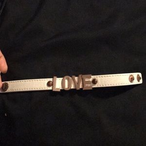 Cream colored bracelet with gold love letters